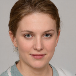 Joyful white young-adult female with medium  brown hair and blue eyes