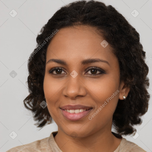 Joyful black young-adult female with medium  brown hair and brown eyes