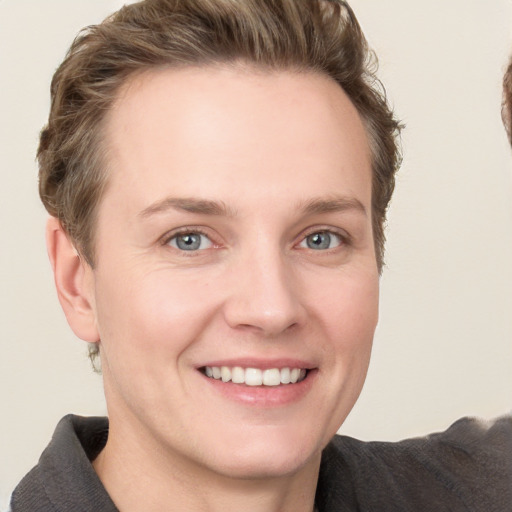 Joyful white young-adult female with short  brown hair and grey eyes