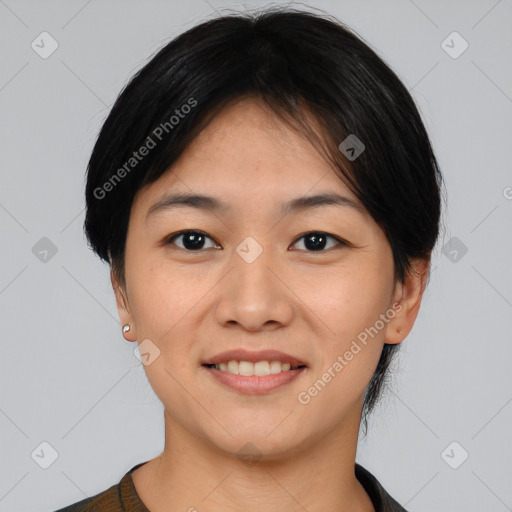 Joyful asian young-adult female with short  black hair and brown eyes