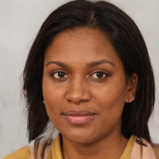 Joyful black young-adult female with medium  brown hair and brown eyes