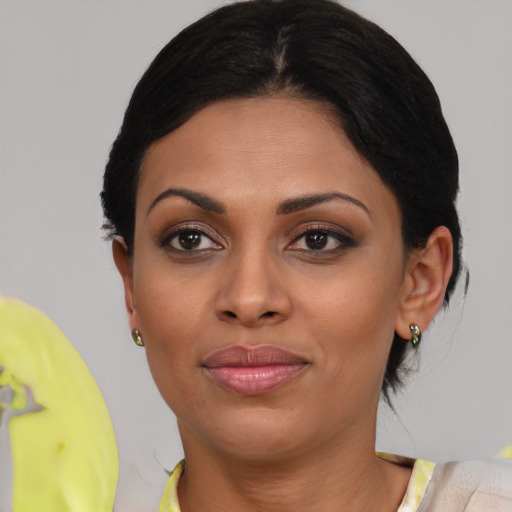 Joyful black young-adult female with medium  brown hair and brown eyes