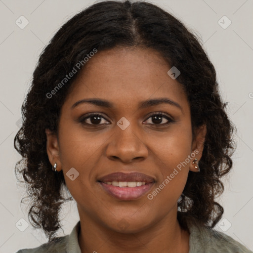 Joyful black young-adult female with long  brown hair and brown eyes