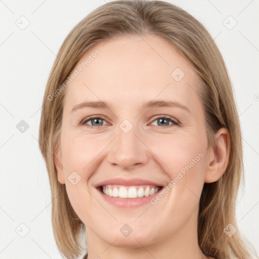 Joyful white young-adult female with long  brown hair and grey eyes