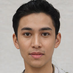 Joyful asian young-adult male with short  black hair and brown eyes