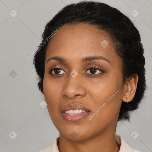 Joyful black young-adult female with short  black hair and brown eyes