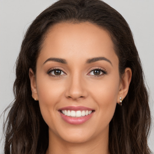 Joyful white young-adult female with long  brown hair and brown eyes