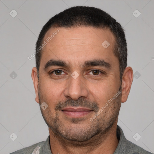 Joyful white adult male with short  black hair and brown eyes