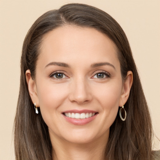 Joyful white young-adult female with long  brown hair and brown eyes