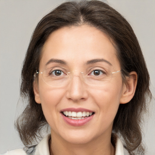 Joyful white adult female with medium  brown hair and brown eyes