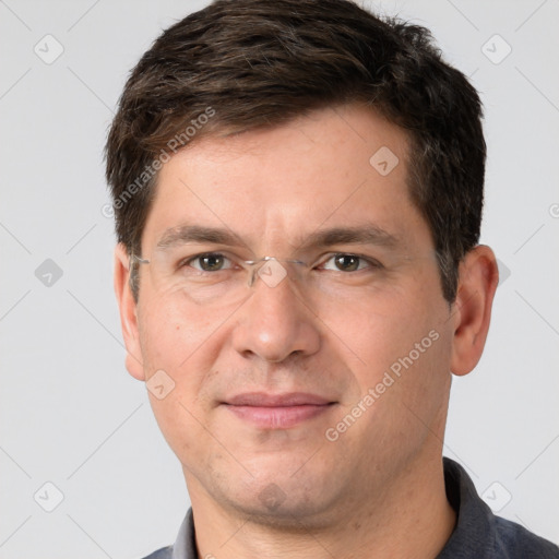 Joyful white adult male with short  brown hair and grey eyes