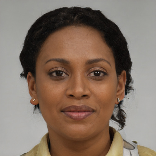 Joyful black adult female with medium  brown hair and brown eyes