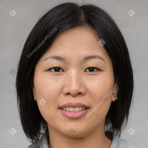 Joyful asian adult female with medium  brown hair and brown eyes