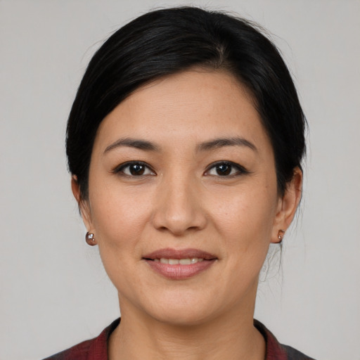 Joyful white young-adult female with medium  black hair and brown eyes