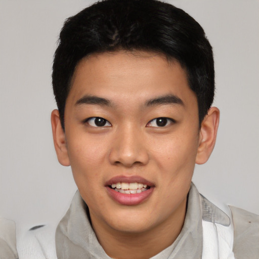 Joyful asian young-adult male with short  black hair and brown eyes