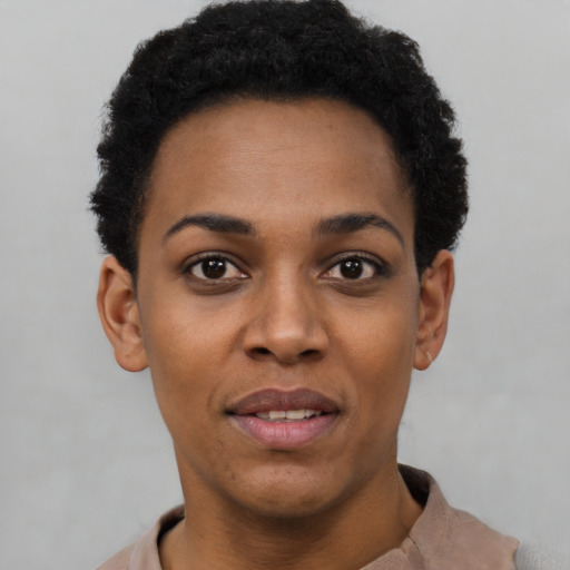 Joyful black young-adult female with short  black hair and brown eyes