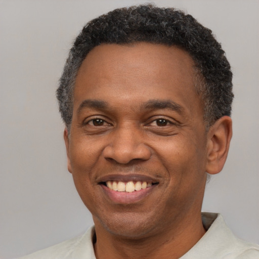 Joyful latino adult male with short  brown hair and brown eyes