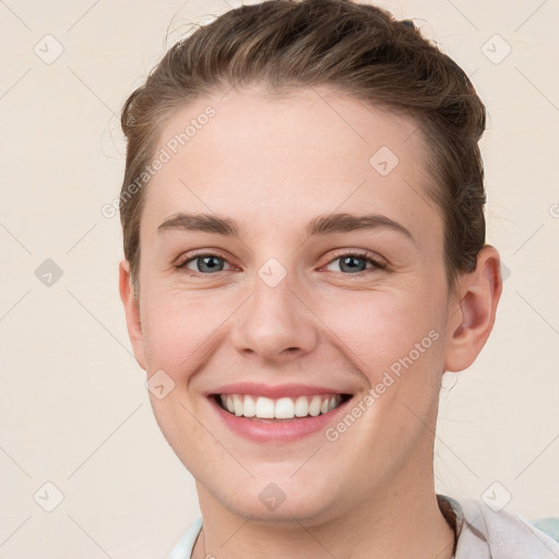 Joyful white young-adult female with short  brown hair and grey eyes