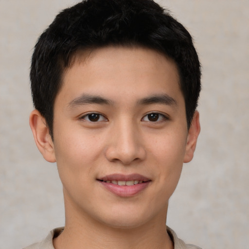 Joyful asian young-adult male with short  brown hair and brown eyes
