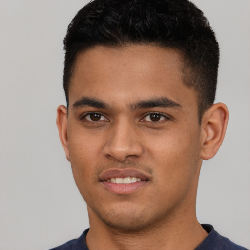 Joyful latino young-adult male with short  black hair and brown eyes