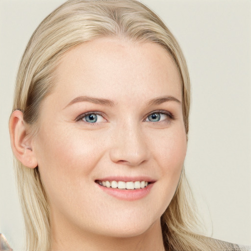 Joyful white young-adult female with long  brown hair and blue eyes