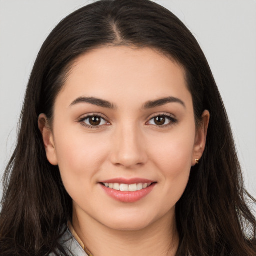 Joyful white young-adult female with long  brown hair and brown eyes