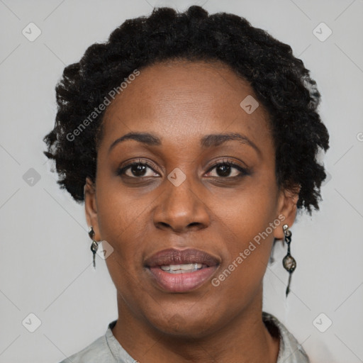 Joyful black adult female with short  black hair and brown eyes