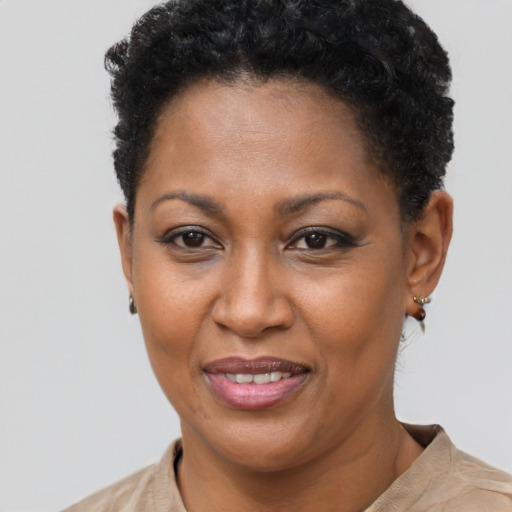 Joyful black adult female with short  brown hair and brown eyes