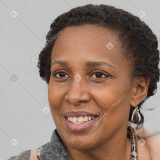 Joyful black adult female with short  brown hair and brown eyes