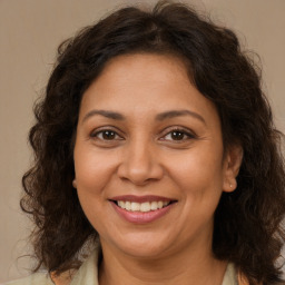 Joyful white adult female with medium  brown hair and brown eyes