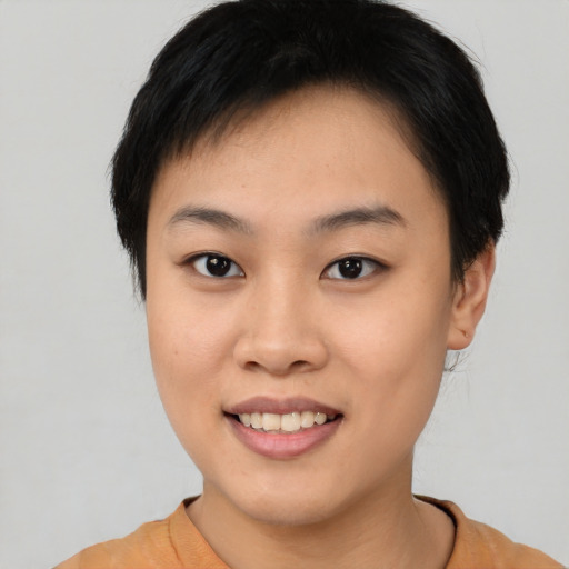 Joyful asian young-adult female with short  black hair and brown eyes
