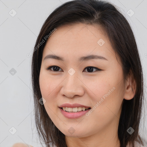 Joyful white young-adult female with long  brown hair and brown eyes