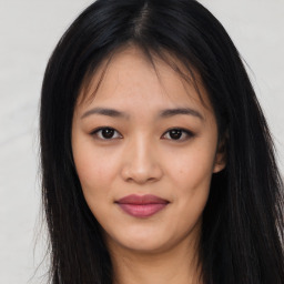 Joyful asian young-adult female with long  brown hair and brown eyes