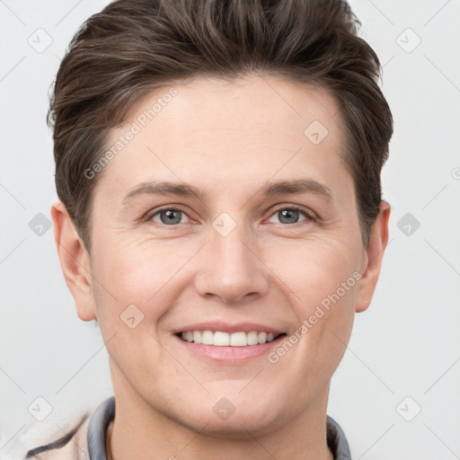 Joyful white young-adult female with short  brown hair and grey eyes