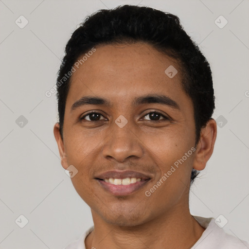 Joyful latino young-adult male with short  black hair and brown eyes