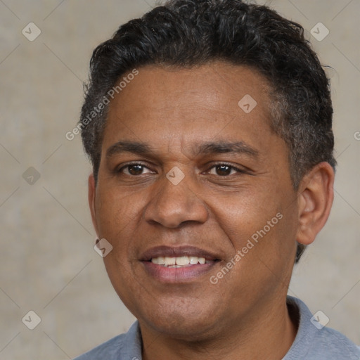 Joyful black adult male with short  black hair and brown eyes
