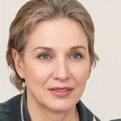 Joyful white adult female with medium  brown hair and grey eyes