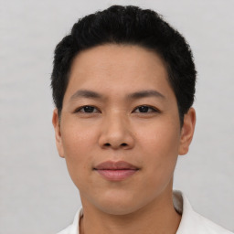 Joyful asian young-adult male with short  black hair and brown eyes