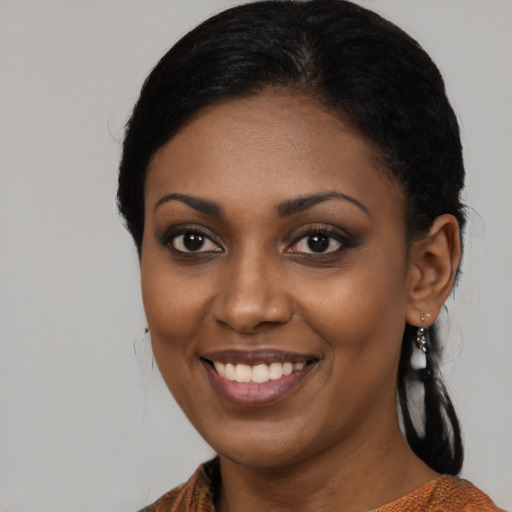 Joyful black young-adult female with medium  black hair and brown eyes