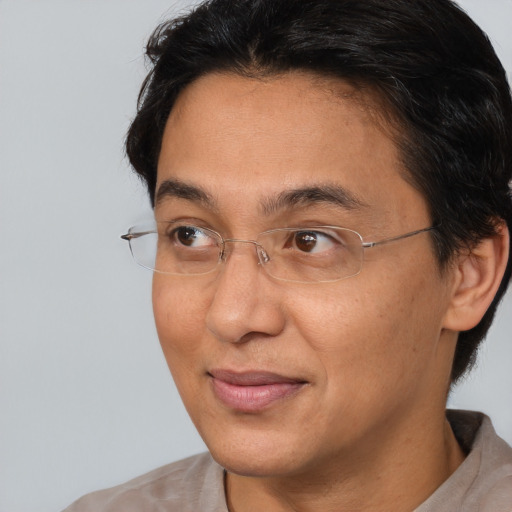 Joyful asian adult male with short  brown hair and brown eyes