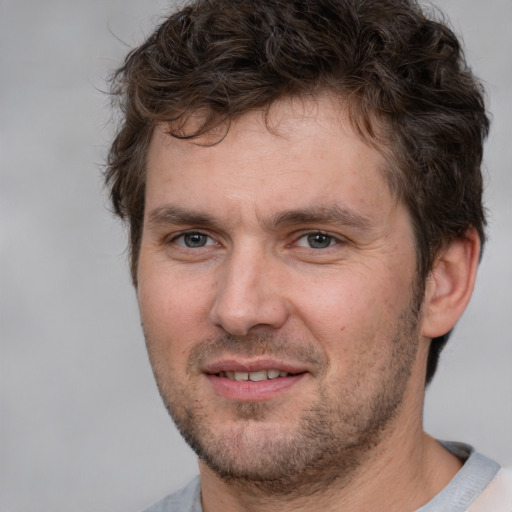 Joyful white adult male with short  brown hair and brown eyes