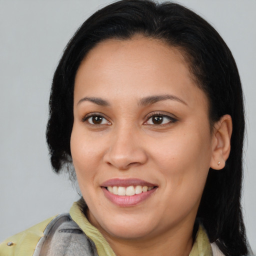 Joyful latino young-adult female with medium  brown hair and brown eyes