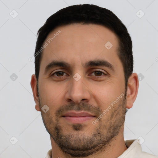 Joyful white young-adult male with short  black hair and brown eyes