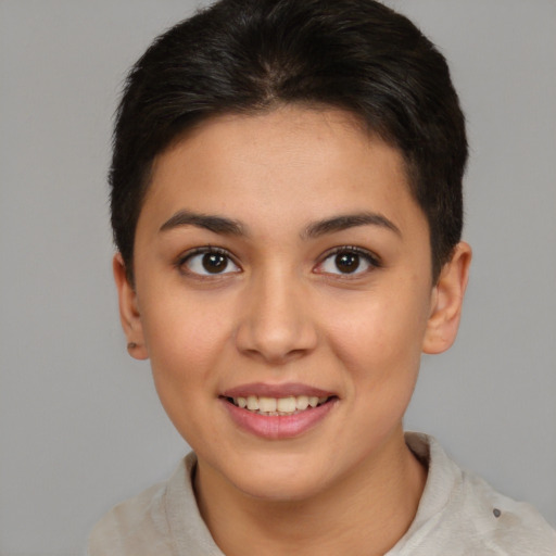 Joyful latino young-adult female with short  brown hair and brown eyes