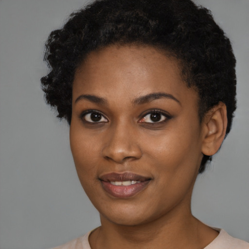 Joyful black young-adult female with short  brown hair and brown eyes