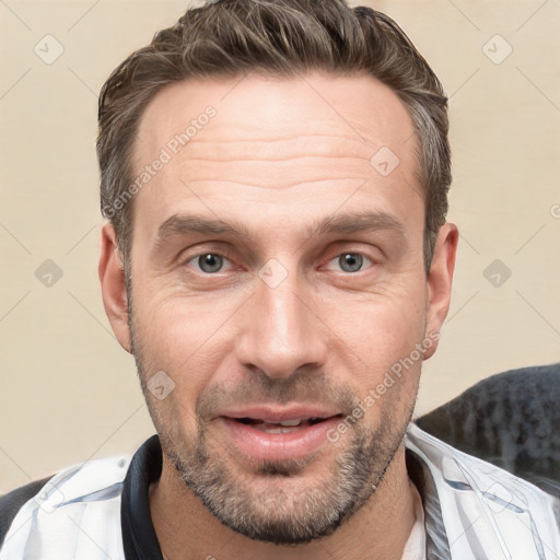 Joyful white adult male with short  brown hair and grey eyes