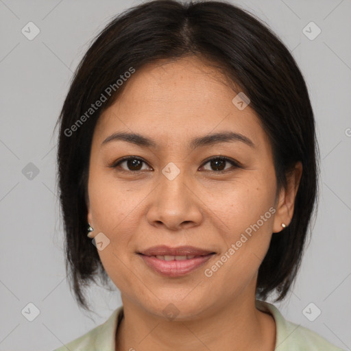 Joyful asian adult female with medium  brown hair and brown eyes