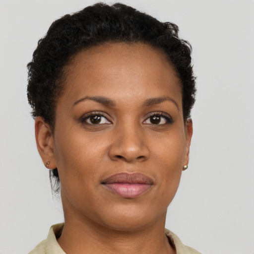 Joyful black young-adult female with short  brown hair and brown eyes