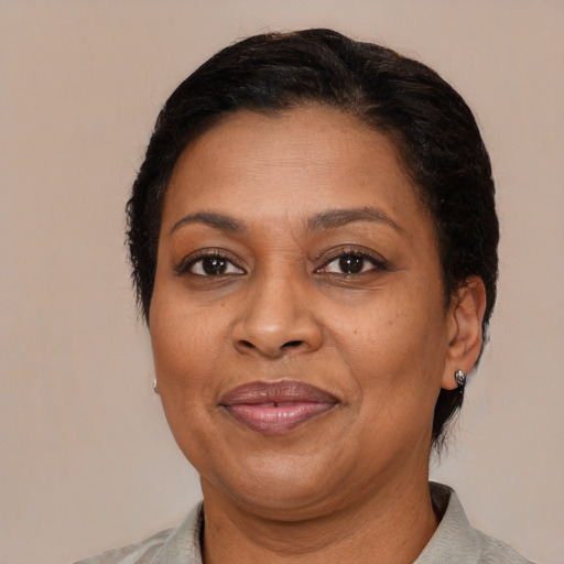 Joyful black adult female with short  brown hair and brown eyes