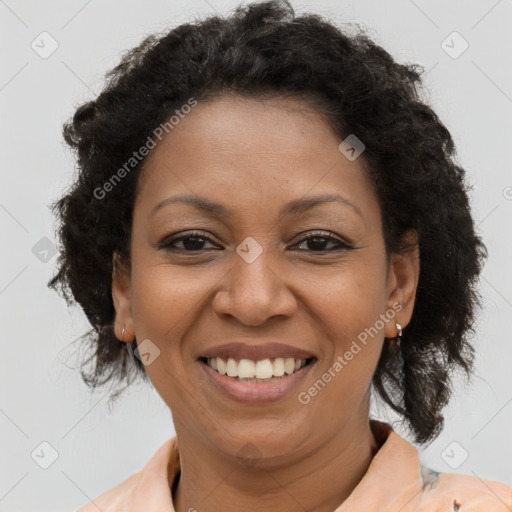 Joyful black adult female with medium  brown hair and brown eyes